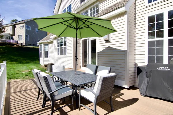 a view of a patio with table and chairs under an umbrella