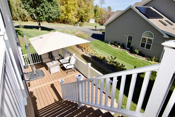 a view of a patio with table and chairs with wooden floor and fence