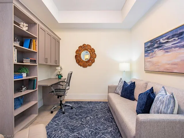 a view of an apartment with a garden and sitting area