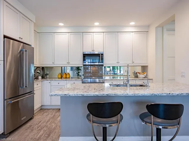 a kitchen with a sink stove and refrigerator