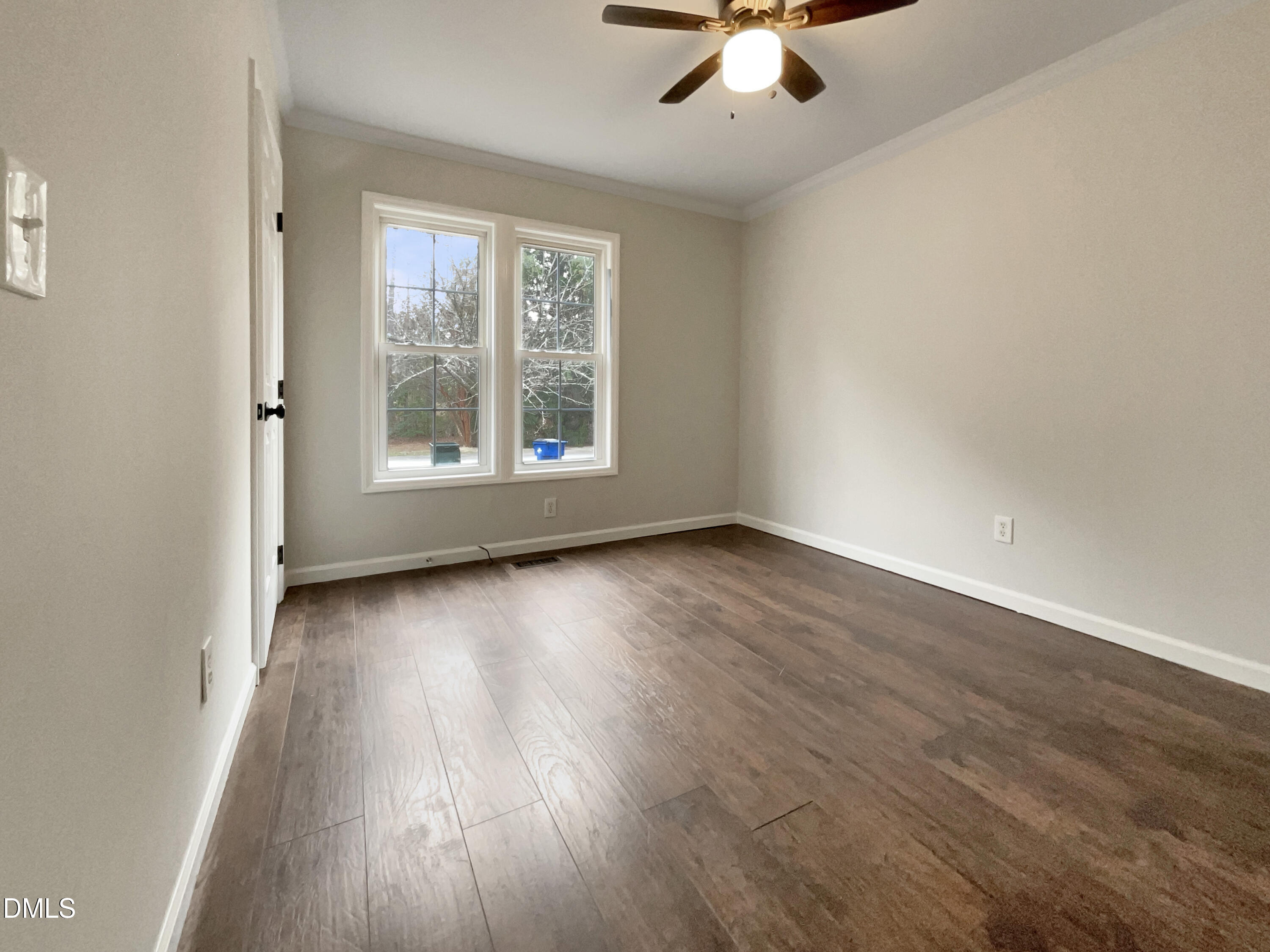 3501 Streams Of Fields Drive Raleigh, NC 27604 - Photo 12 of 16 an empty room with wooden floor chandelier fan and windows