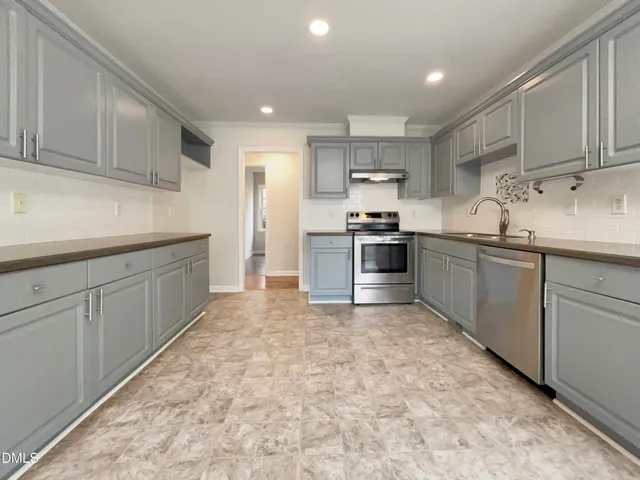 a kitchen with stainless steel appliances granite countertop a sink and cabinets