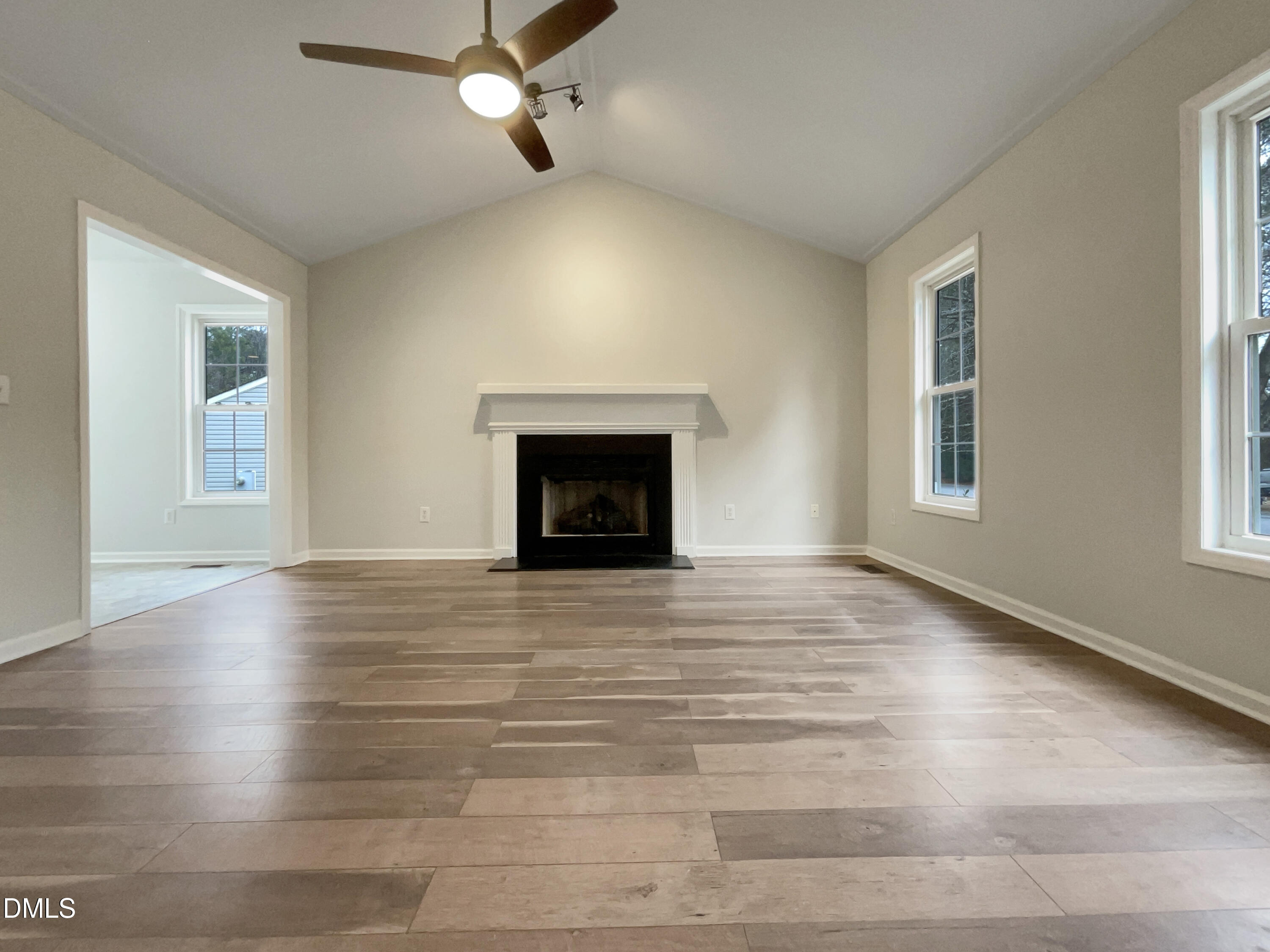 3501 Streams Of Fields Drive Raleigh, NC 27604 - Photo 3 of 16 an empty room with wooden floor fireplace and windows