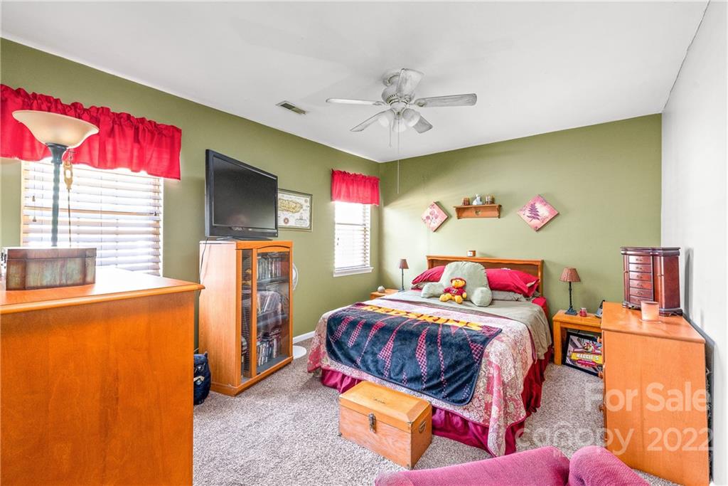 1531 Crestdale Road Rock Hill, SC 29732 - Photo 11 of 20 a bedroom with a bed and a chandelier