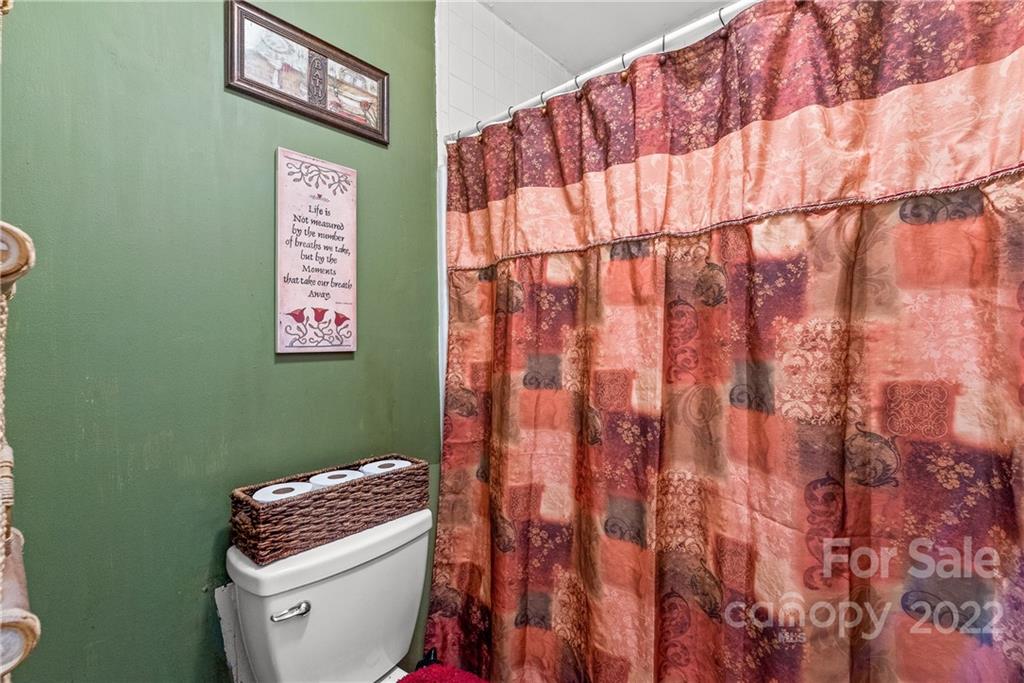 1531 Crestdale Road Rock Hill, SC 29732 - Photo 13 of 20 a bathroom with a toilet and a shower curtain