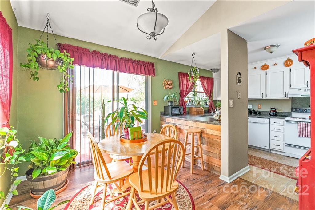 1531 Crestdale Road Rock Hill, SC 29732 - Photo 7 of 20 a dining room with furniture a potted plant and a rug