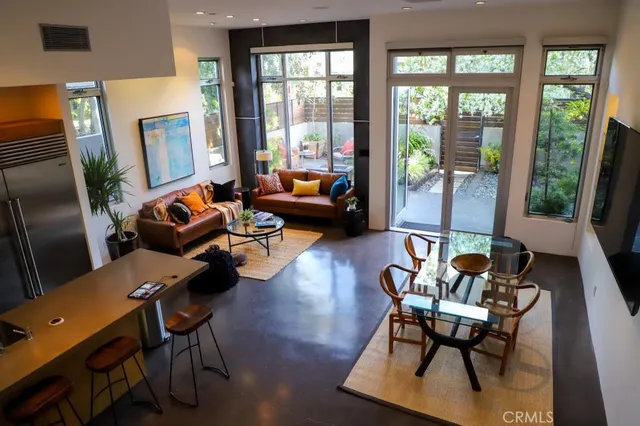 a living room with furniture and floor to ceiling windows