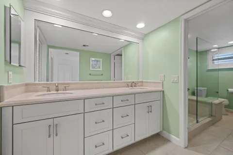 a bathroom with double sink and a mirror