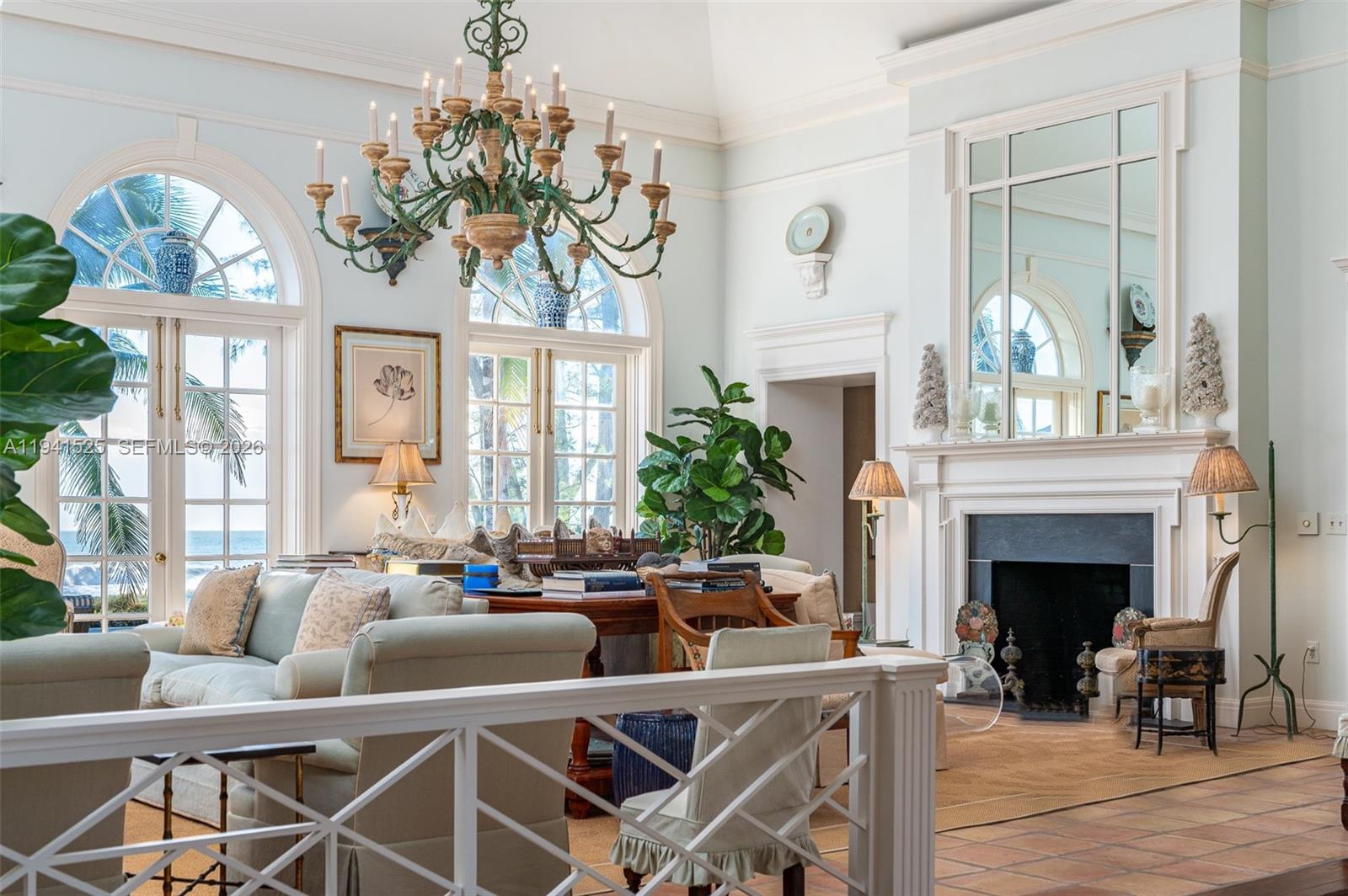 21 South Beach Road Jupiter Island, FL 33455 - Photo 16 of 45 a living room with furniture a fireplace and a chandelier