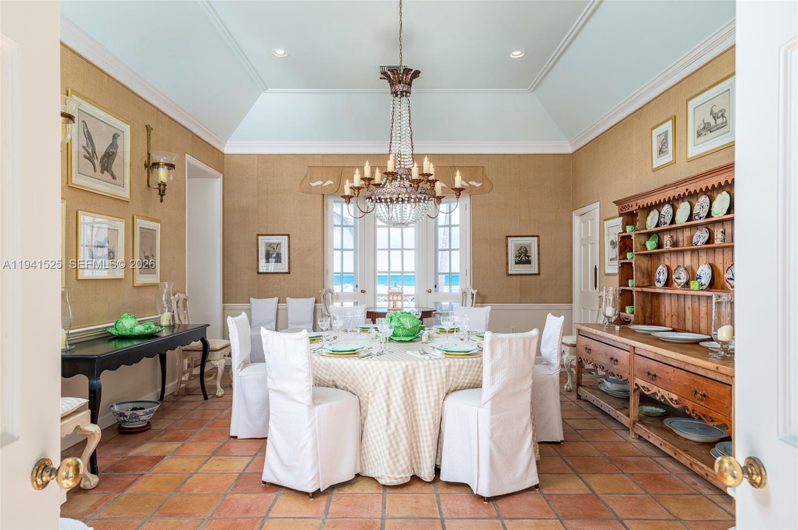 21 South Beach Road Jupiter Island, FL 33455 - Photo 19 of 45 a dining room with furniture a chandelier and window