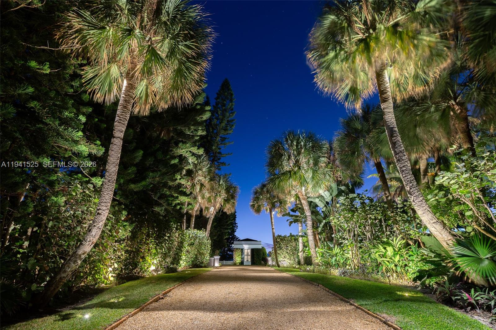 21 South Beach Road Jupiter Island, FL 33455 - Photo 2 of 45 front view of house with a yard and potted plants