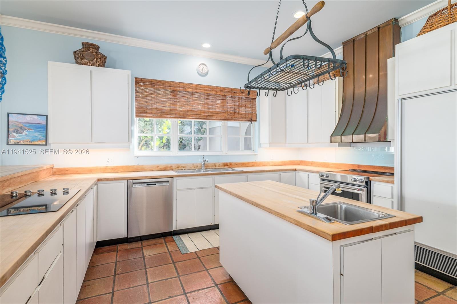 21 South Beach Road Jupiter Island, FL 33455 - Photo 21 of 45 a kitchen with a sink a stove a microwave and cabinets