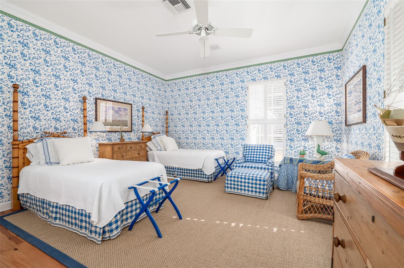 21 South Beach Road Jupiter Island, FL 33455 - Photo 25 of 45 a bedroom with a bed and a couch