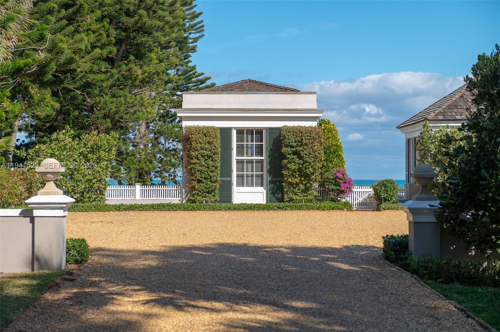 21 South Beach Road Jupiter Island, FL 33455 - Photo 27 of 45 a front view of a house with a yard and garage