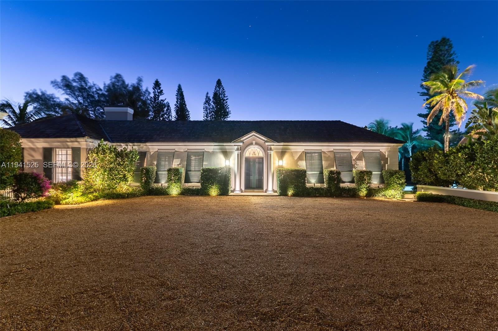 21 South Beach Road Jupiter Island, FL 33455 - Photo 3 of 45 a view of a house with a yard and garage