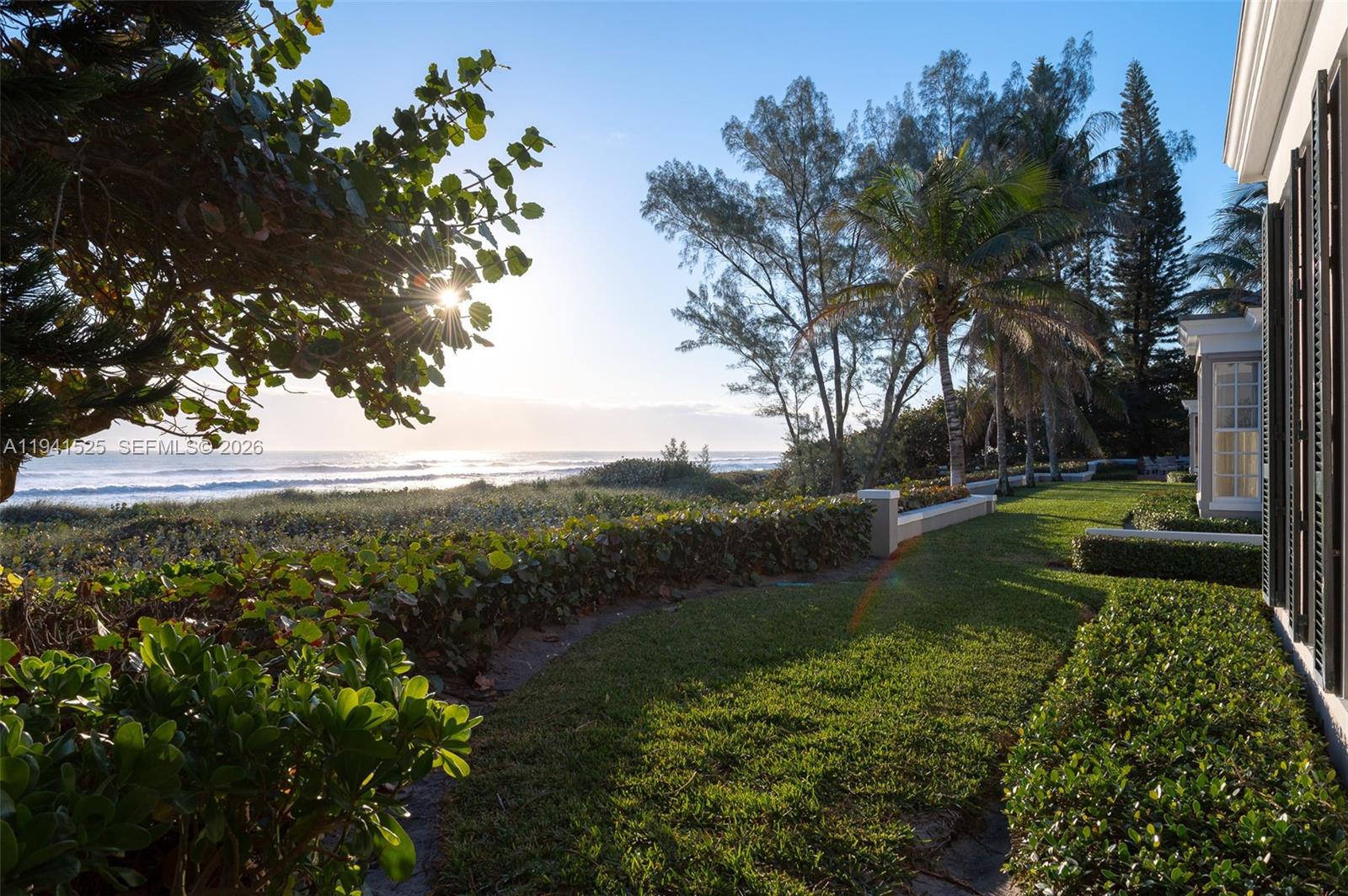 21 South Beach Road Jupiter Island, FL 33455 - Photo 31 of 45 a view of a lake with a yard