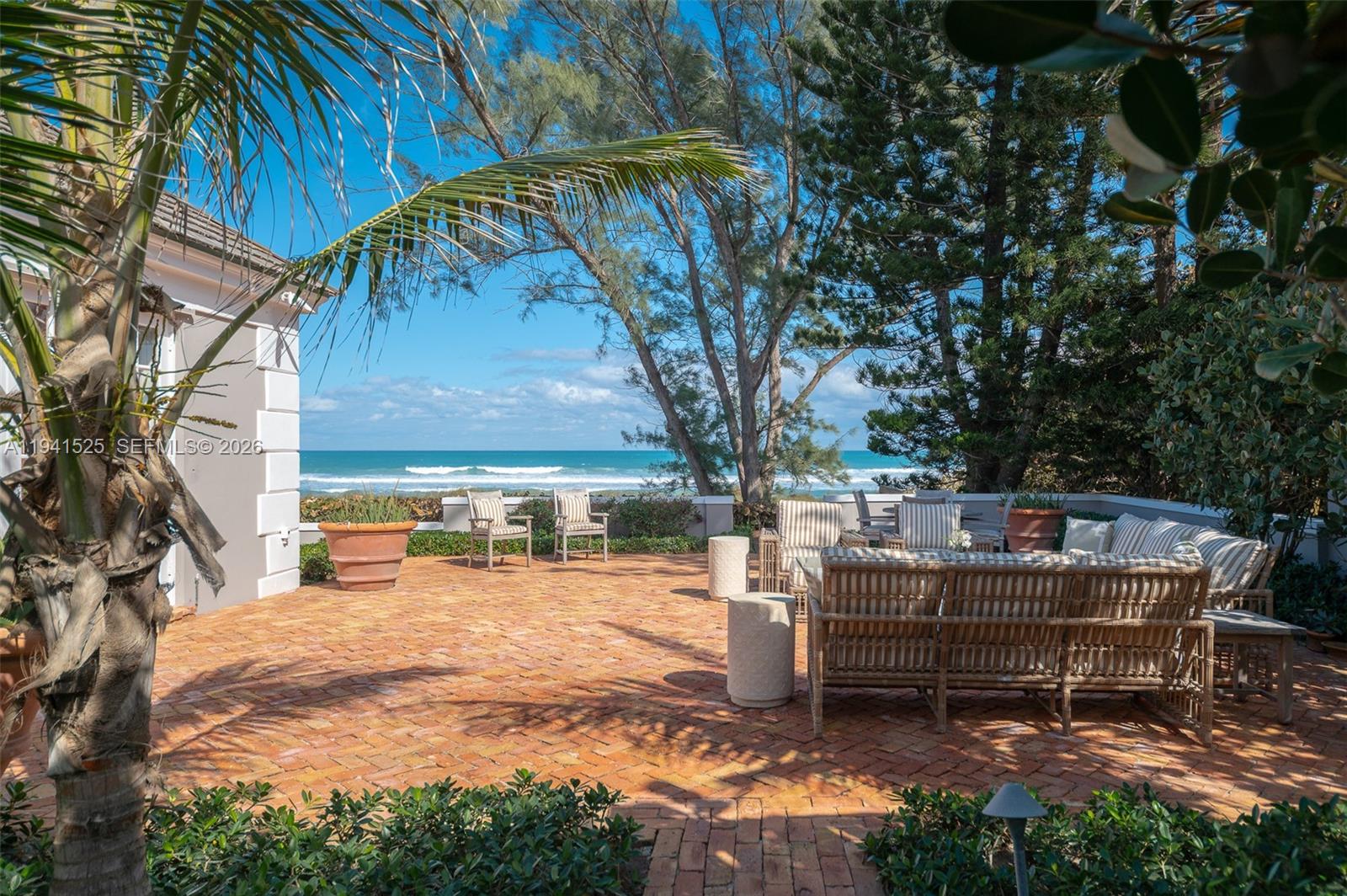 21 South Beach Road Jupiter Island, FL 33455 - Photo 35 of 45 a backyard of a house with fire pit and outdoor seating