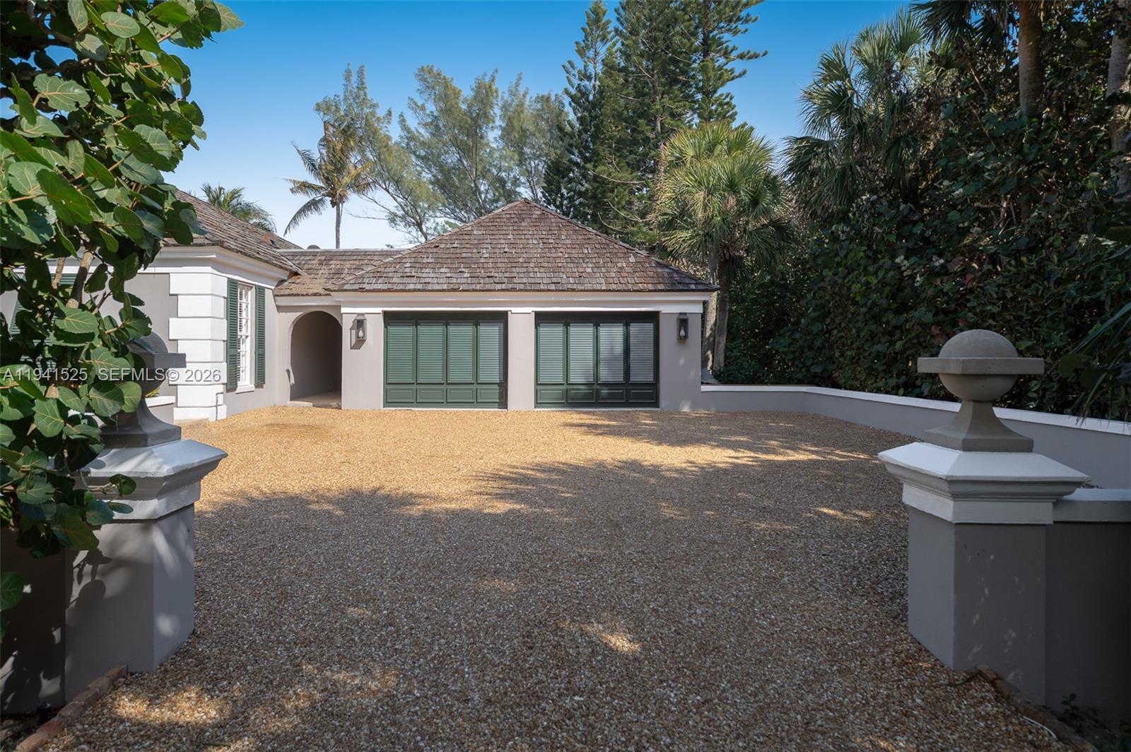 21 South Beach Road Jupiter Island, FL 33455 - Photo 39 of 45 a front view of a house with garden