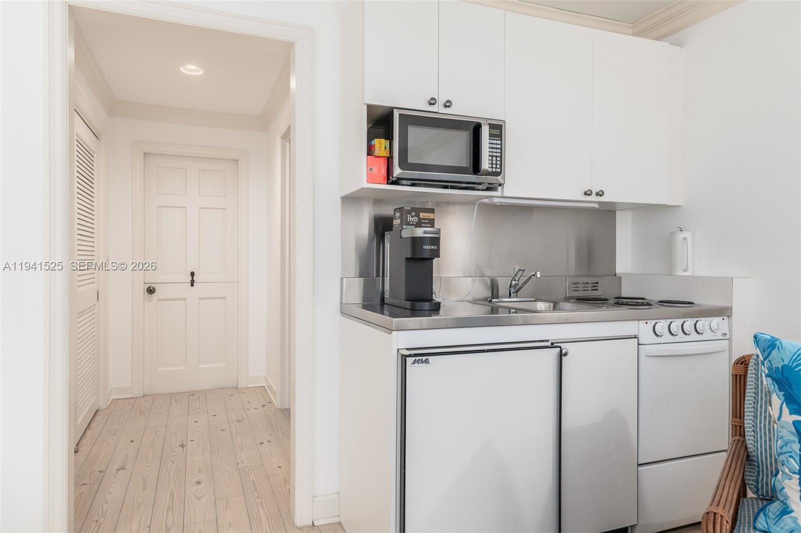 21 South Beach Road Jupiter Island, FL 33455 - Photo 41 of 45 a kitchen with cabinets stainless steel appliances and sink