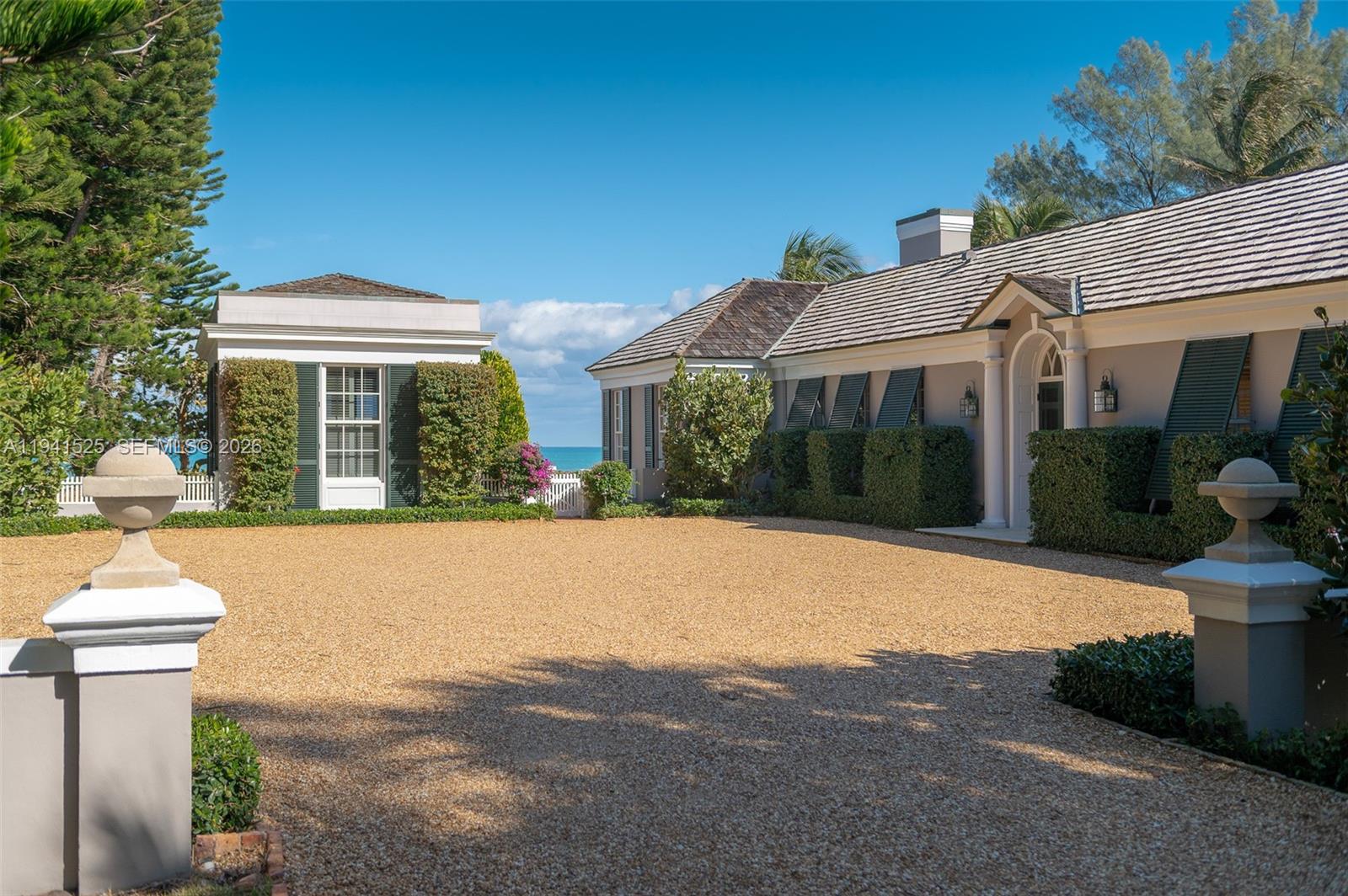 21 South Beach Road Jupiter Island, FL 33455 - Photo 9 of 45 a front view of a house with garden
