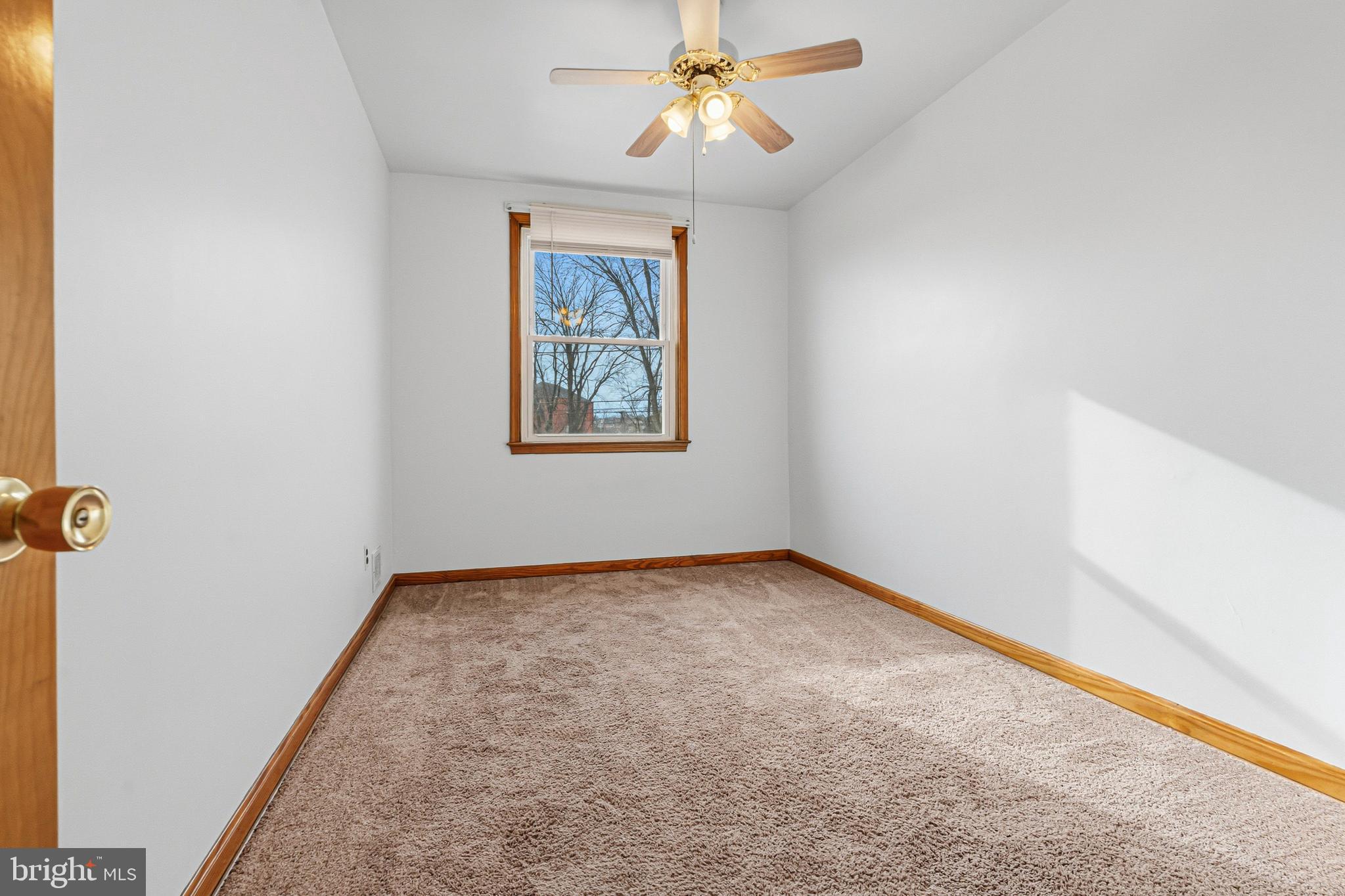 1242 Delbert Avenue Baltimore, MD 21222 - Photo 13 of 34 an empty room with windows and fan