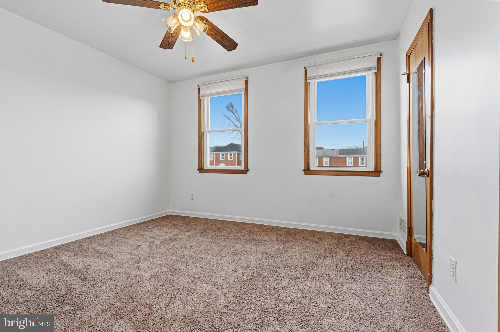 1242 Delbert Avenue Baltimore, MD 21222 - Photo 16 of 34 an empty room with windows and fan