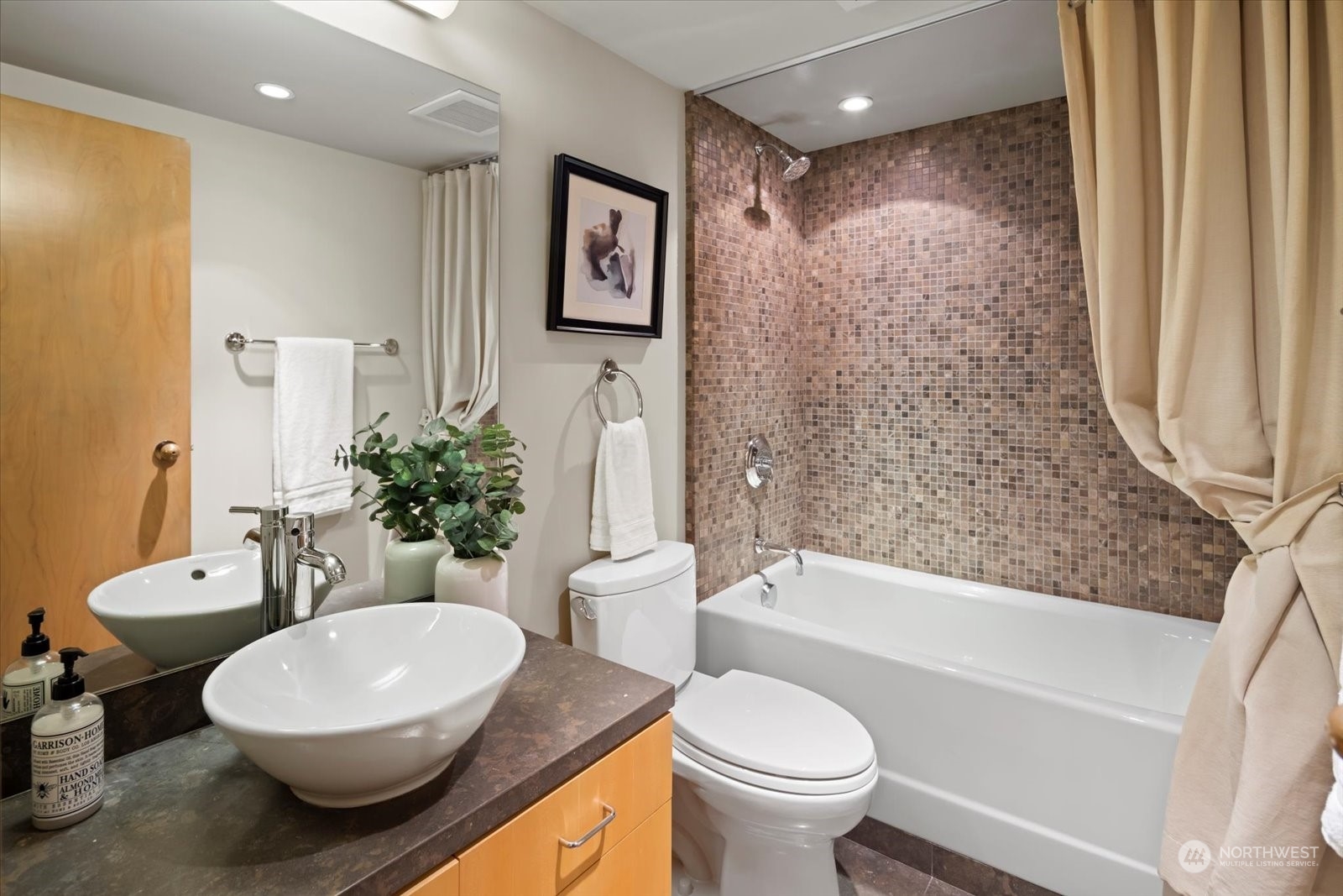 2021 1st Avenue, Unit G2 Seattle, WA 98121 - Photo 15 of 24 a bathroom with a granite countertop toilet sink and bathtub