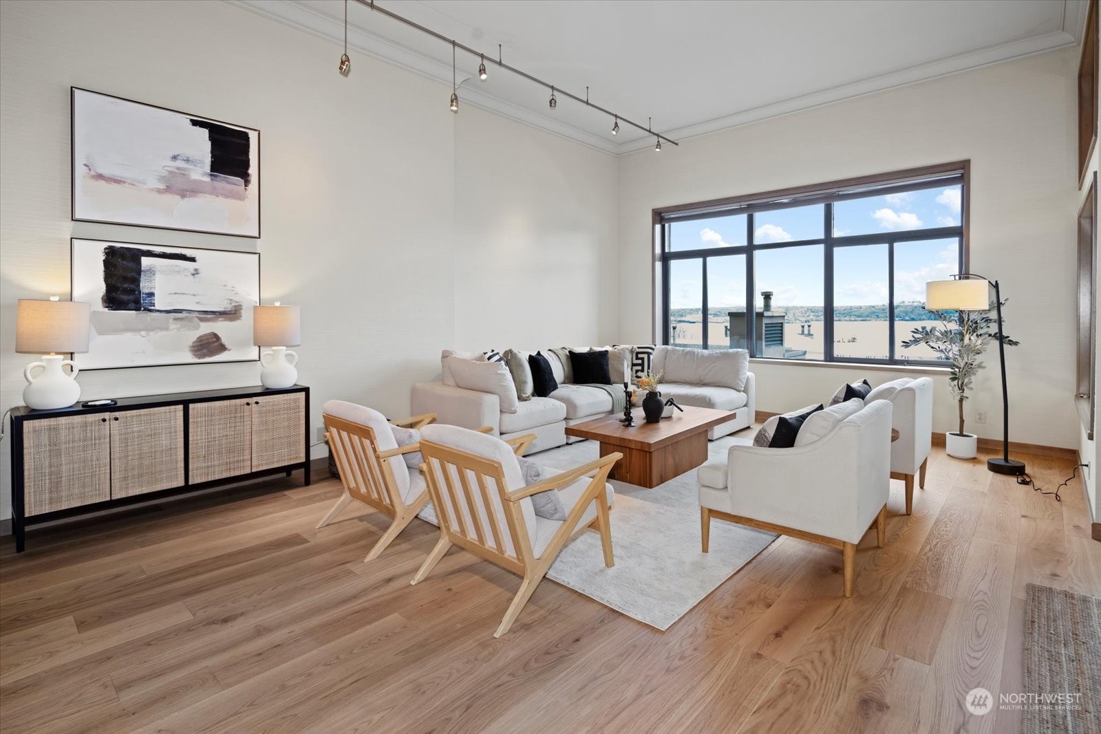 2021 1st Avenue, Unit G2 Seattle, WA 98121 - Photo 2 of 24 a living room with furniture a large window and wooden floor