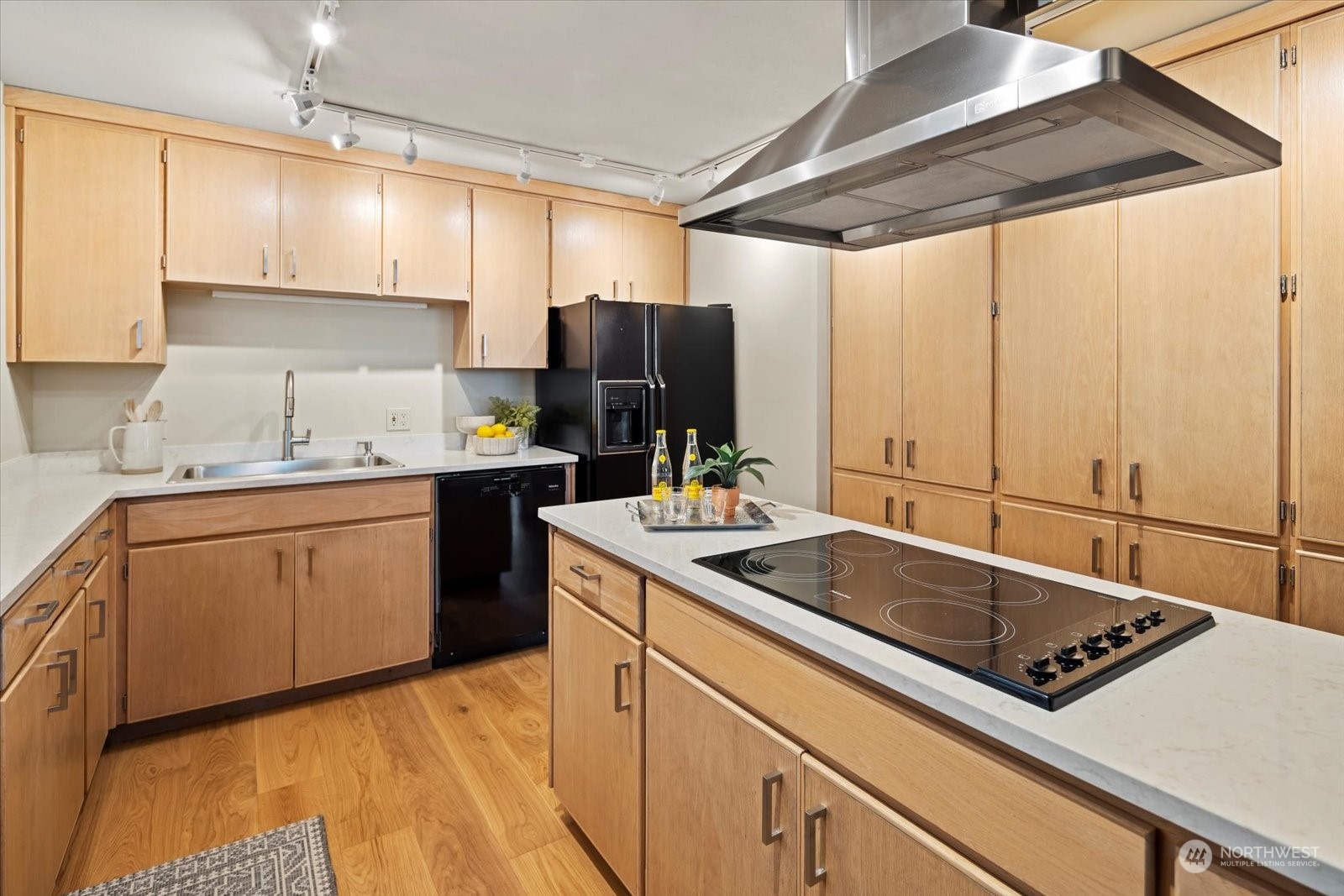 2021 1st Avenue, Unit G2 Seattle, WA 98121 - Photo 9 of 24 a kitchen with a sink stove and cabinets