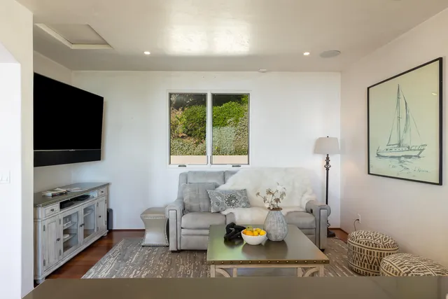 a kitchen with granite countertop white cabinets and stainless steel appliances