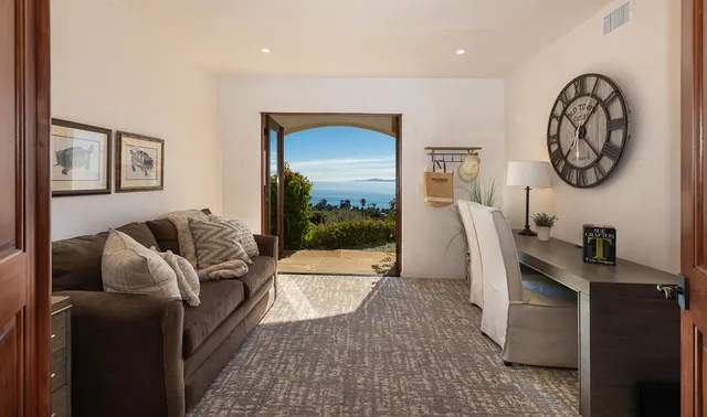 a spacious bedroom with a bed and a flat screen tv