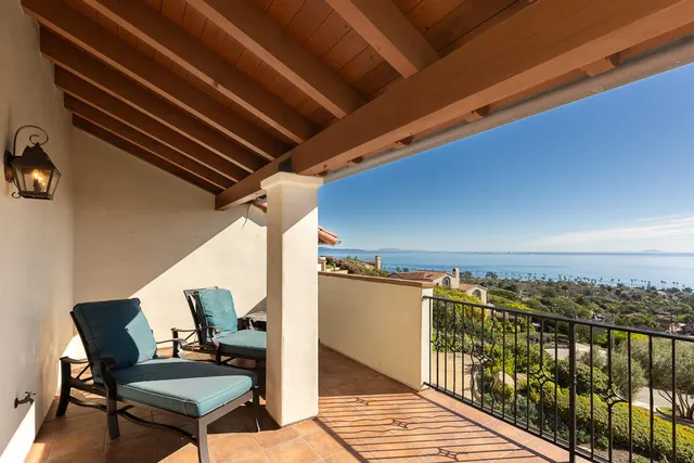 an aerial view of a house with a yard and mountain view in back