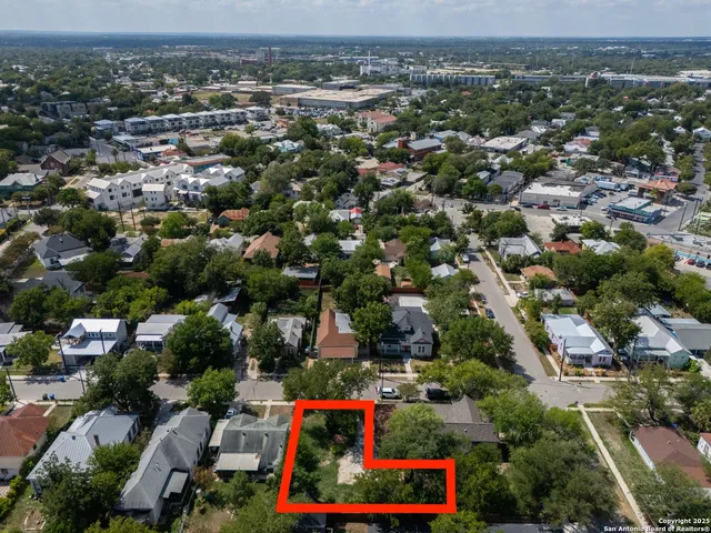 an aerial view of residential houses with outdoor space