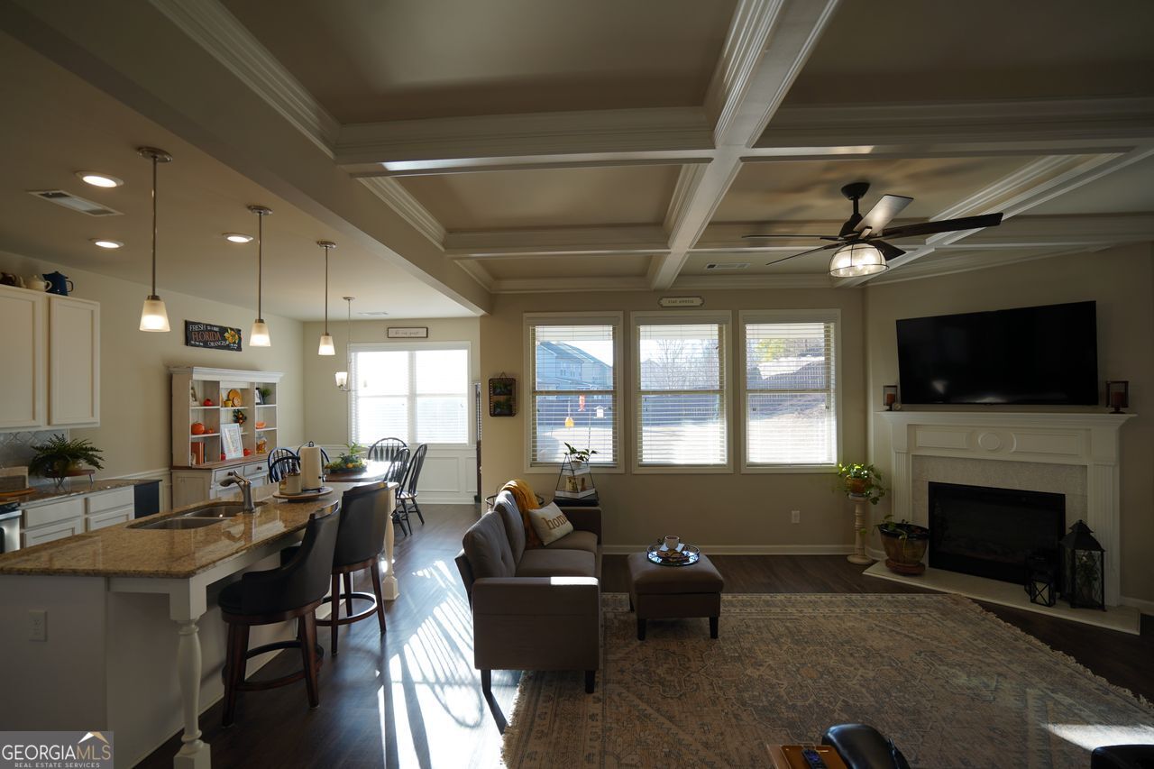 7671 Silk Tree Braselton, GA 30517 - Photo 11 of 92 a living room with furniture a flat screen tv and a fireplace