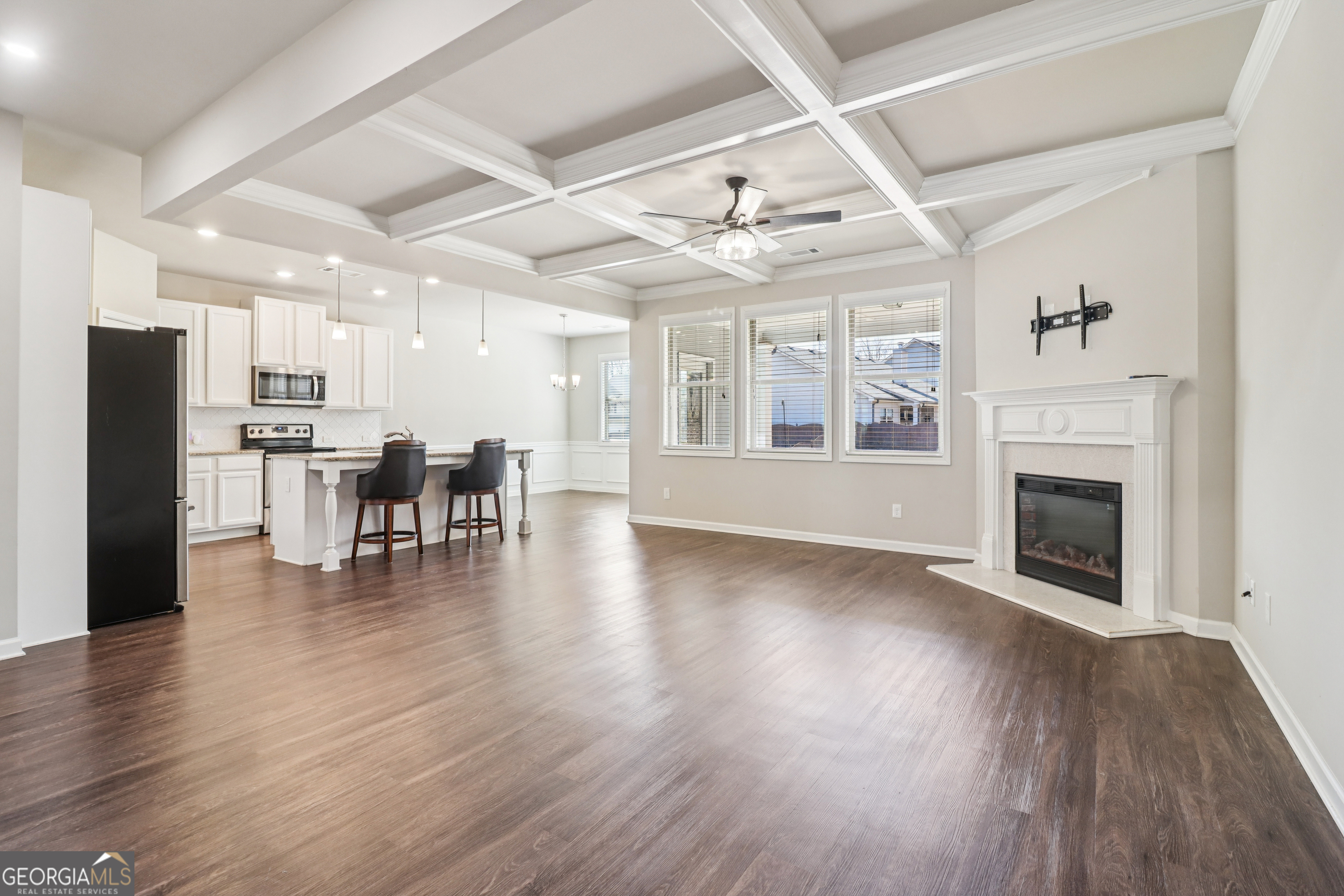 7671 Silk Tree Braselton, GA 30517 - Photo 16 of 92 a view of a livingroom with furniture a fireplace wooden floor and chandelier