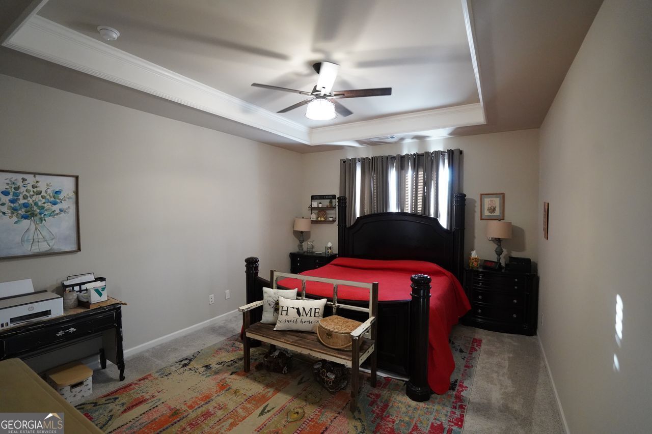 7671 Silk Tree Braselton, GA 30517 - Photo 19 of 92 a bedroom with a bed and a chandelier