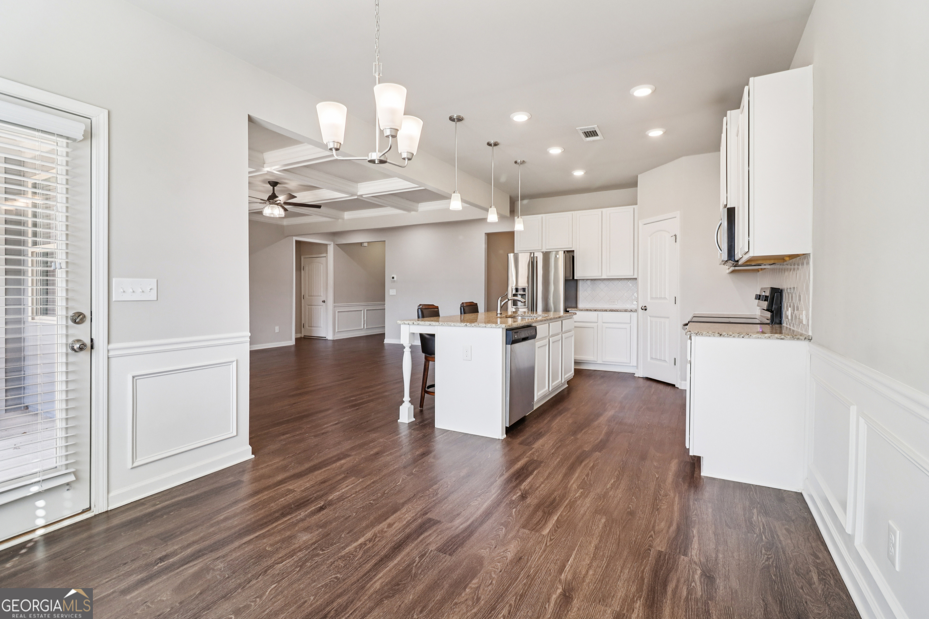 7671 Silk Tree Braselton, GA 30517 - Photo 20 of 92 a kitchen with kitchen island white cabinets and stainless steel appliances