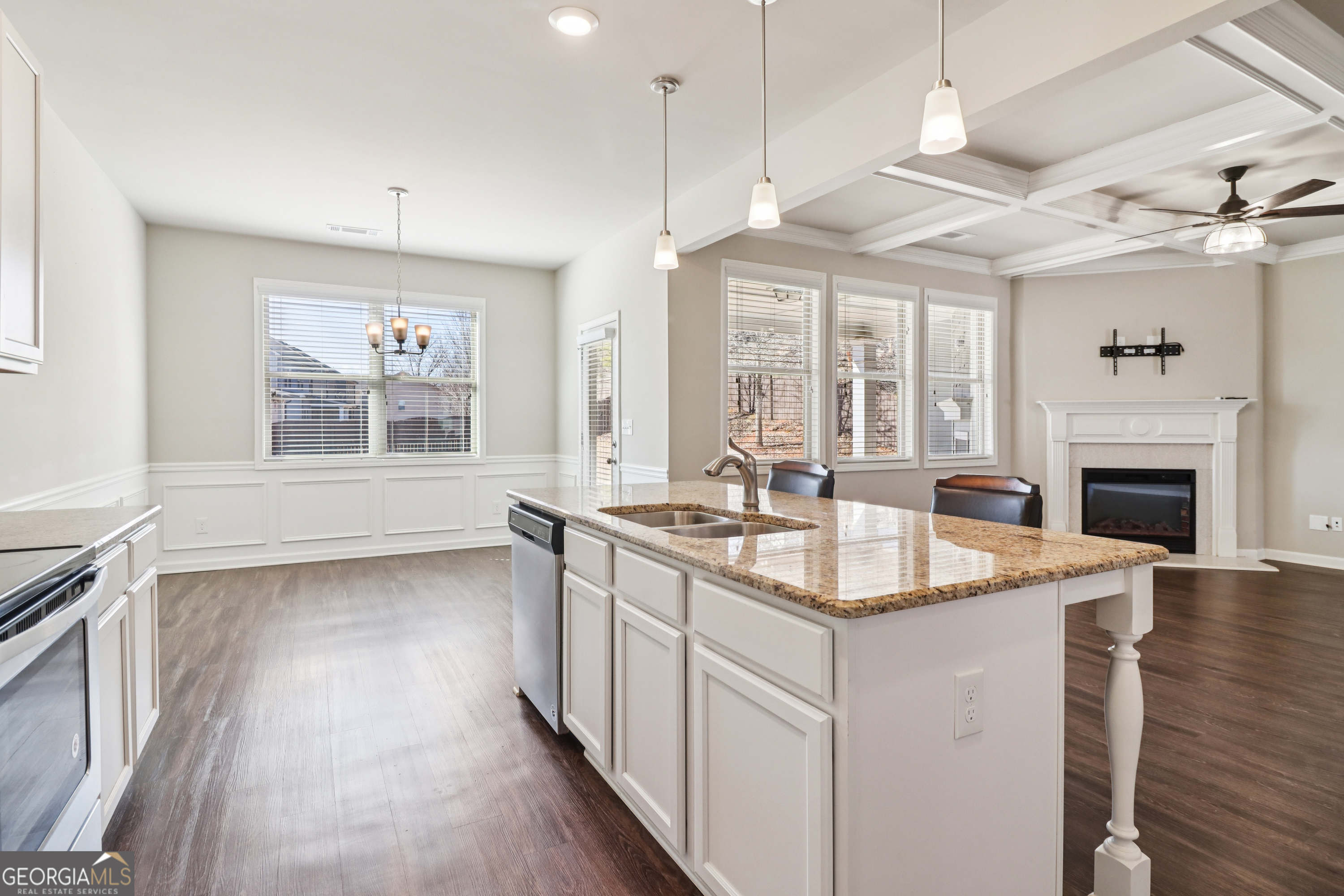7671 Silk Tree Braselton, GA 30517 - Photo 28 of 92 a open kitchen with granite countertop a sink stove and wooden floor