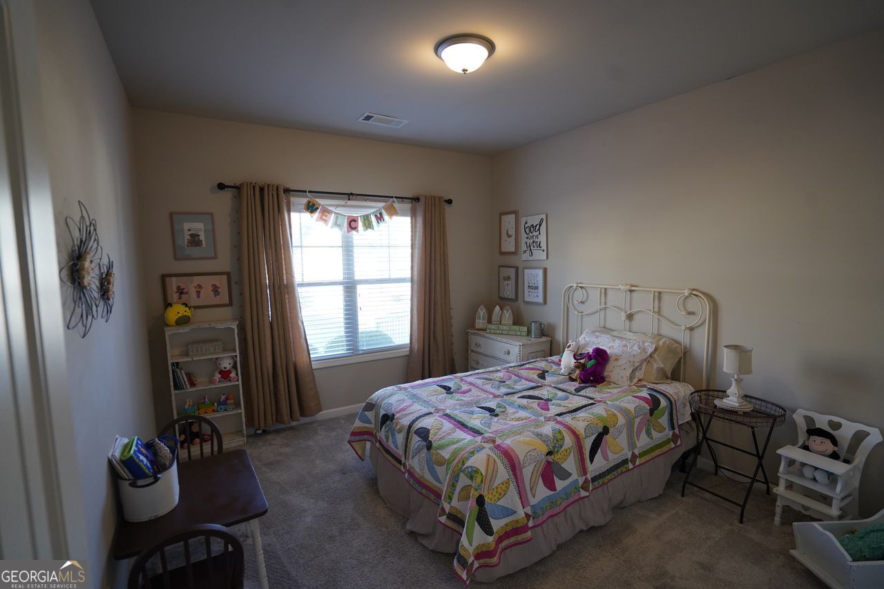 7671 Silk Tree Braselton, GA 30517 - Photo 43 of 92 a bedroom with a bed and a window