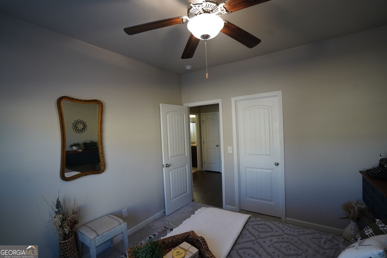 7671 Silk Tree Braselton, GA 30517 - Photo 51 of 92 a bedroom with a bed and a chandelier