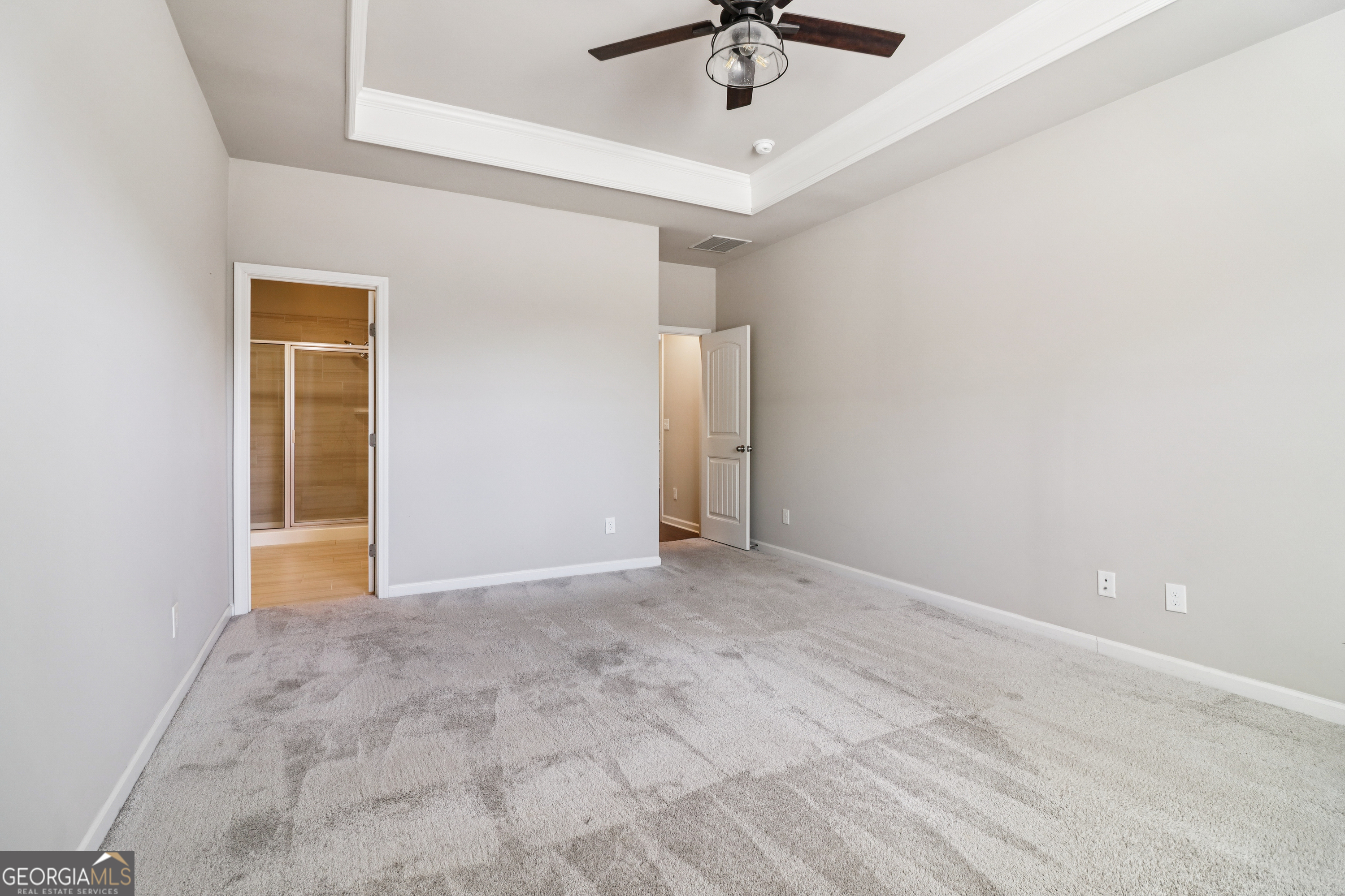 7671 Silk Tree Braselton, GA 30517 - Photo 52 of 92 an empty room with a ceiling fan and carpet