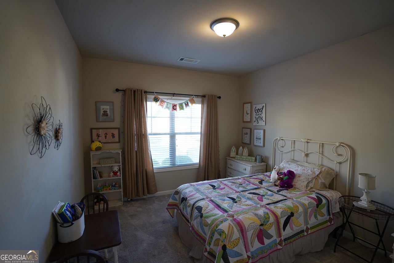 7671 Silk Tree Braselton, GA 30517 - Photo 53 of 92 a bedroom with a bed and a window