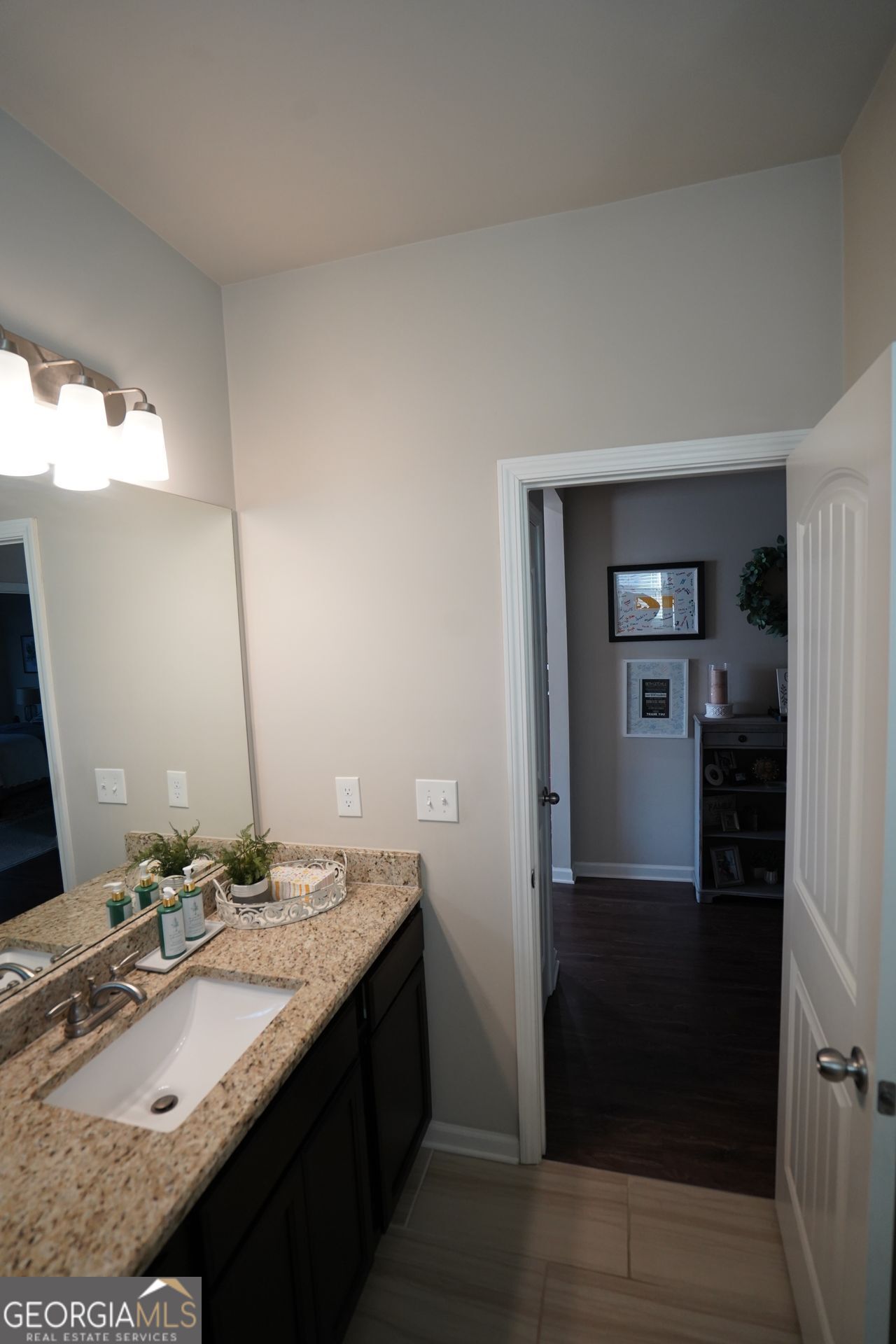 7671 Silk Tree Braselton, GA 30517 - Photo 59 of 92 a bathroom with a granite countertop sink and a mirror