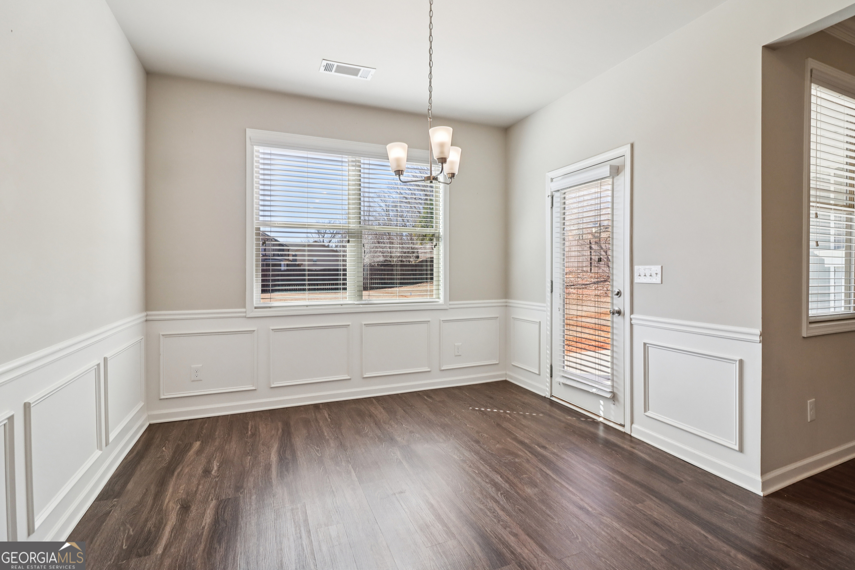 7671 Silk Tree Braselton, GA 30517 - Photo 76 of 92 a view of an empty room with wooden floor and a window