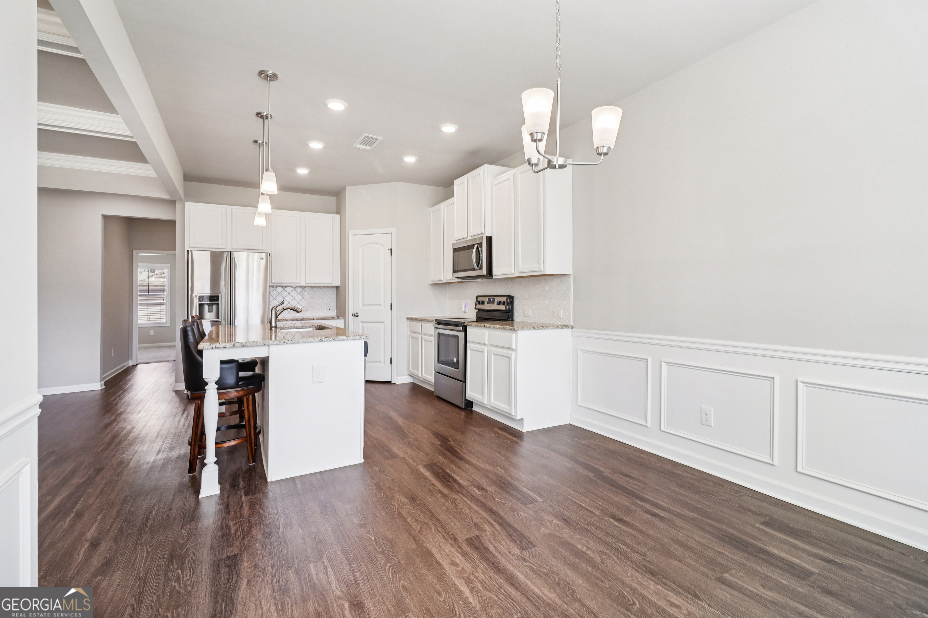7671 Silk Tree Braselton, GA 30517 - Photo 80 of 92 a open kitchen with white cabinets and stainless steel appliances
