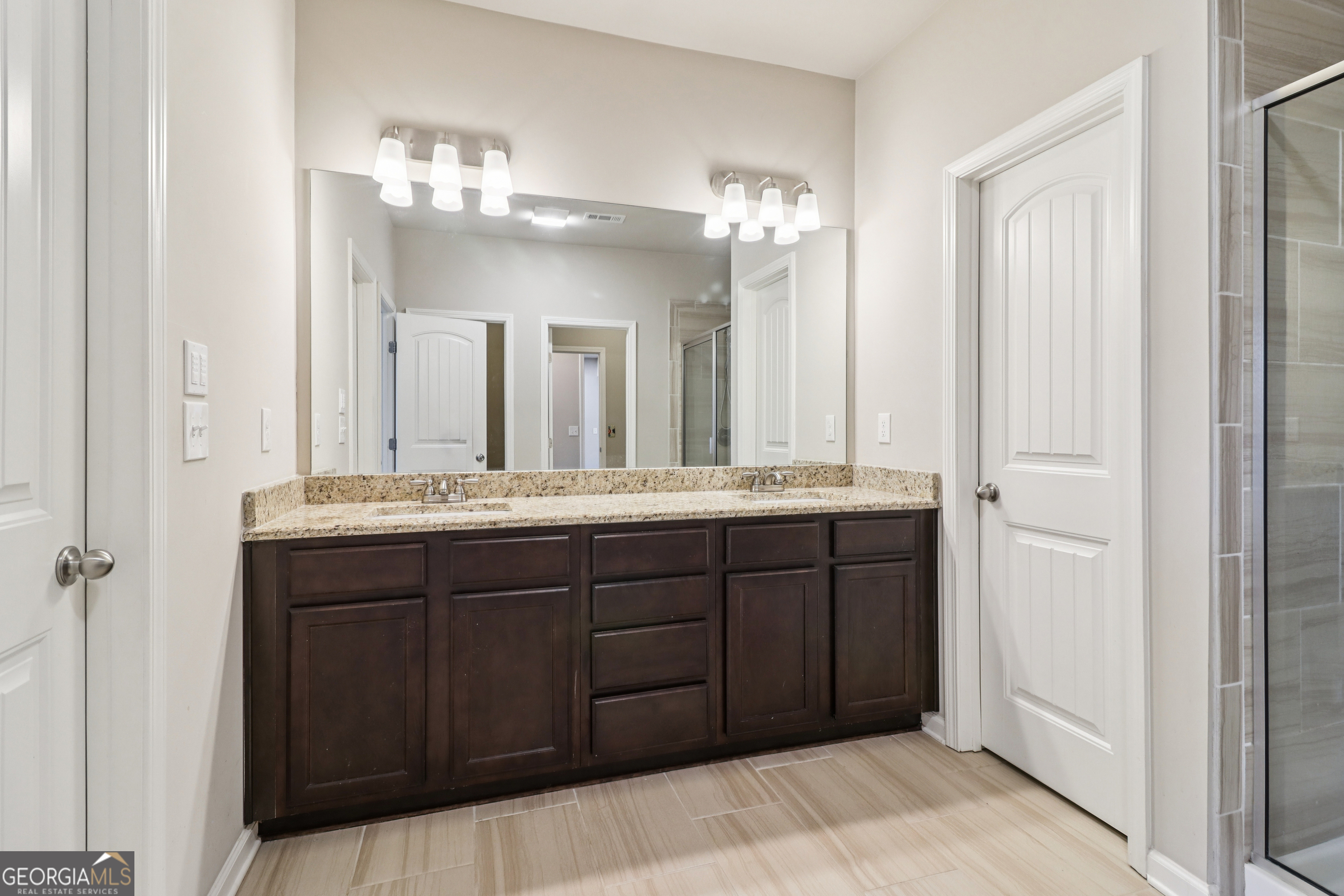 7671 Silk Tree Braselton, GA 30517 - Photo 89 of 92 a bathroom with a double vanity sink and a mirror