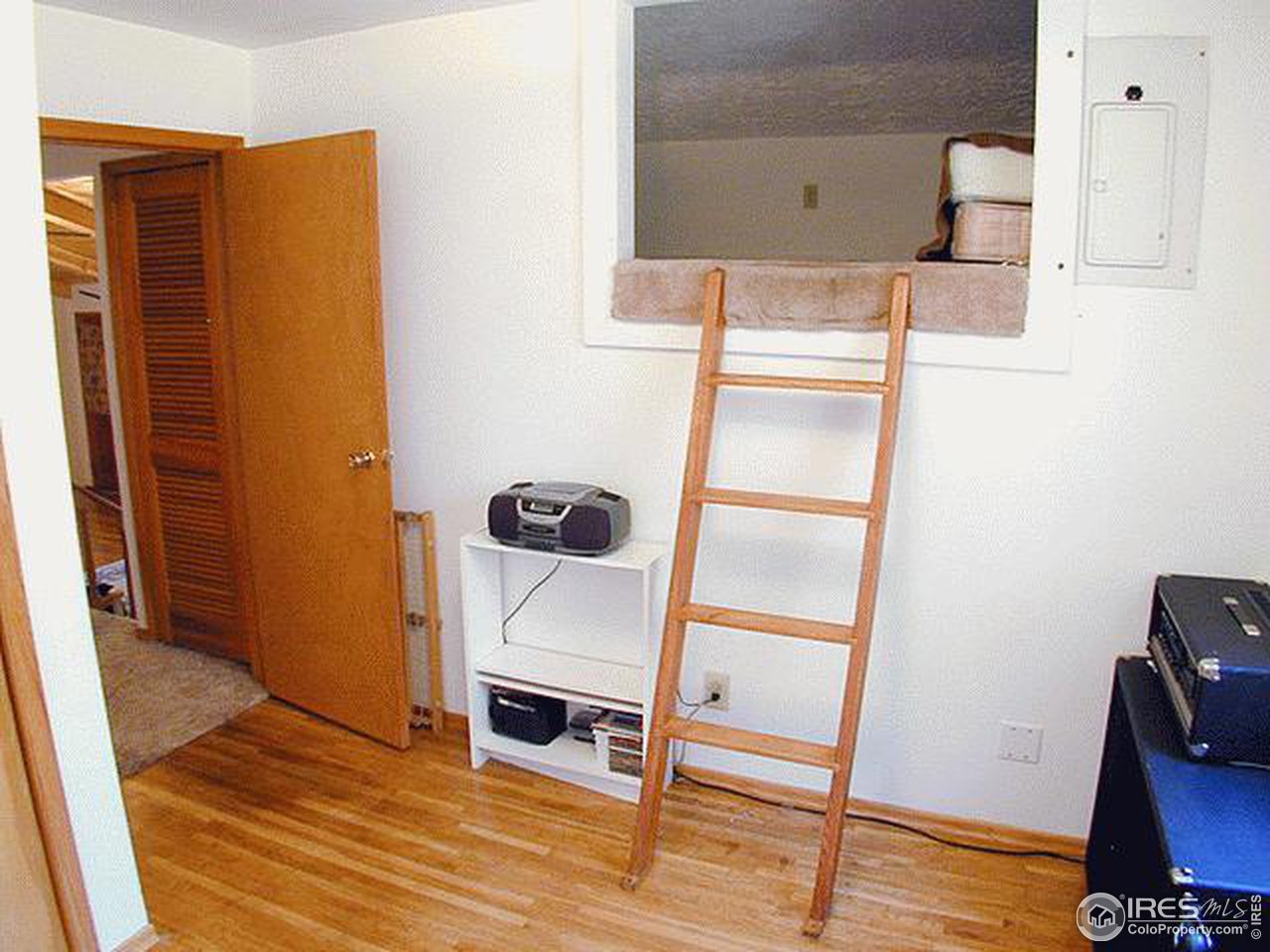 9431 Rist Canyon Road Bellvue, CO 80512 - Photo 13 of 15 a room with a door and wooden floor