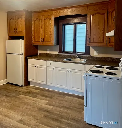 a kitchen with stainless steel appliances granite countertop a refrigerator and a stove