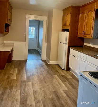 a kitchen with stainless steel appliances granite countertop a refrigerator a stove and a sink with granite countertops