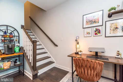 a view of a hallway with seating area and furniture